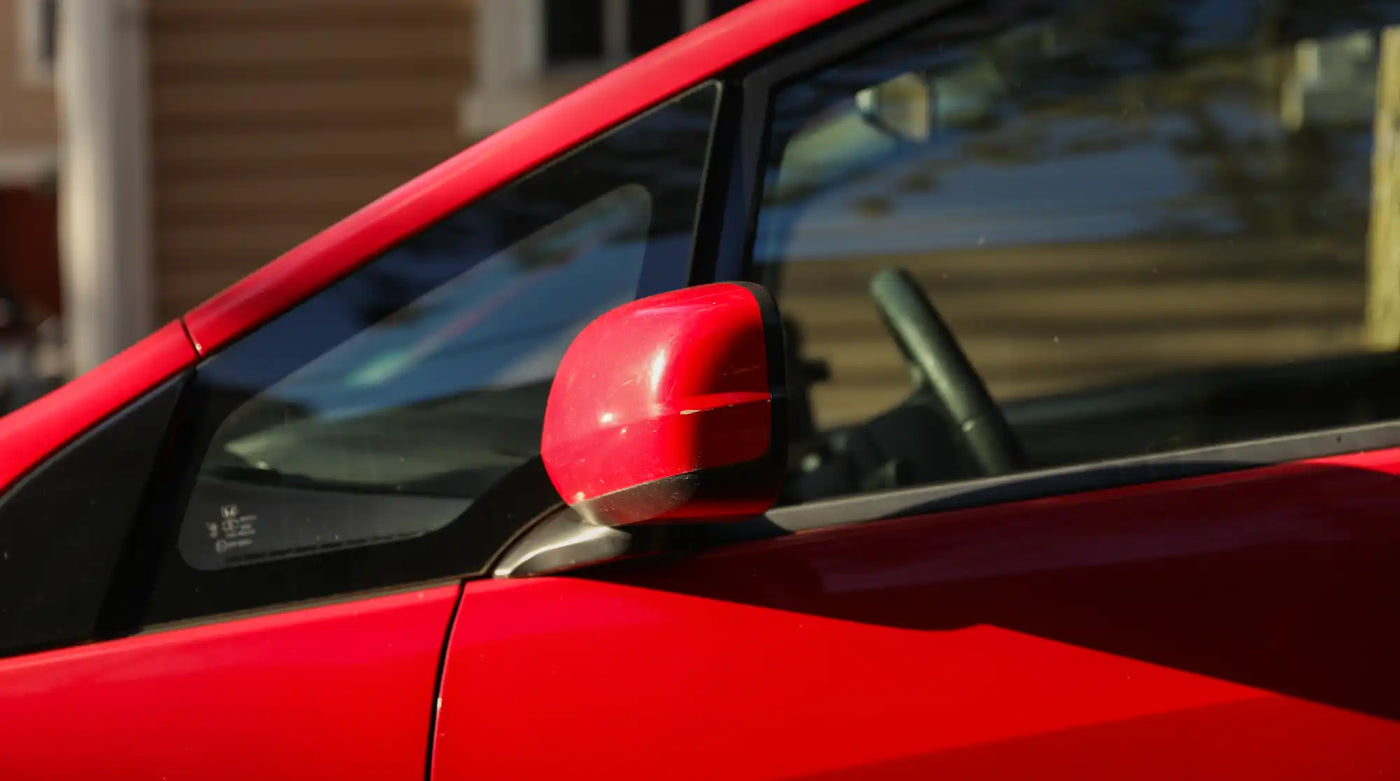 Red side mirror of a car.