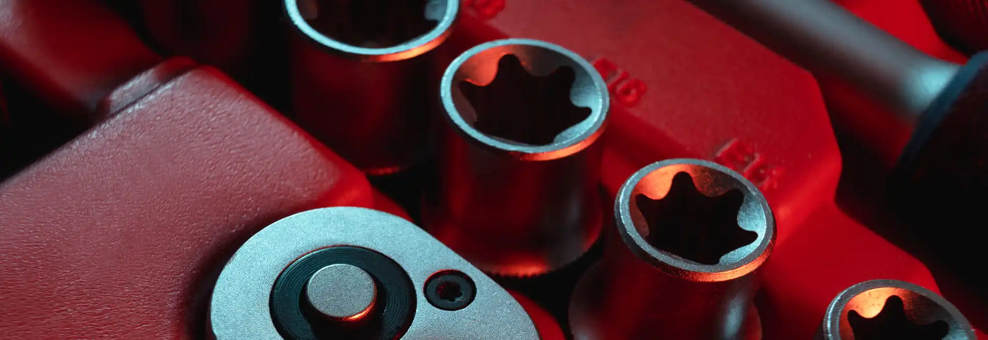 Red video game controller with black buttons and analog sticks.