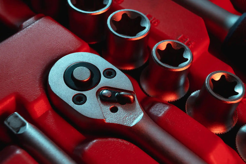 Socket wrench head with multiple socket attachments.
